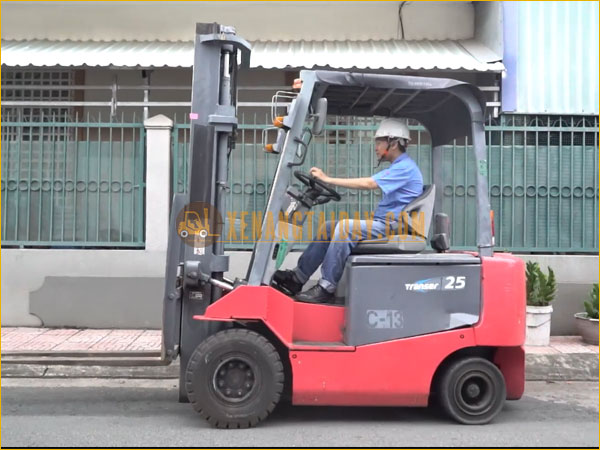 a man wearing a face mask on a forklift